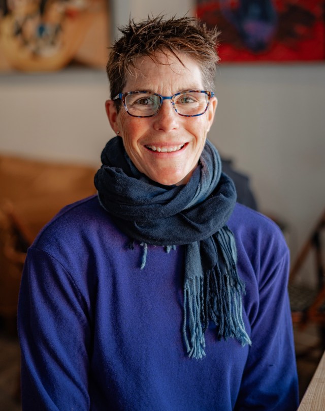 Photo of Vicki Thomas.
Vicki is wearing a purple sweater and a blue scarf. Vicki has blue glasses and brown hair.